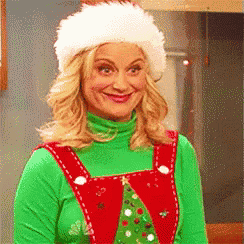 a woman is wearing a santa hat and overalls .