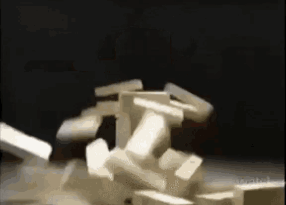 a pile of dominoes are stacked on top of each other on a table