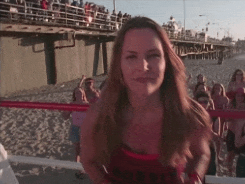 a woman wearing a red tank top that says ' i love you '