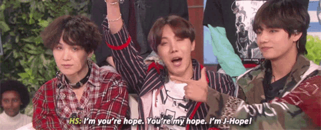 a group of young men are sitting next to each other and one of them is saying hs i 'm your 're hope