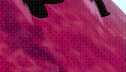 a cartoon character is flying through the air on a pink surface .