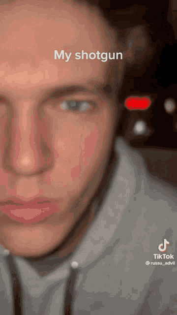 a close up of a man 's face with the words " my shotgun " written on it