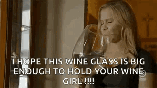 a woman is drinking a glass of wine and saying `` i hope this wine glass is big enough to hold your wine girl . ''
