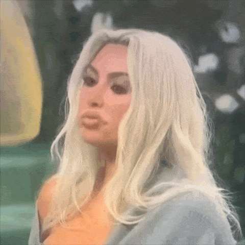 a close up of a woman 's face with long blonde hair