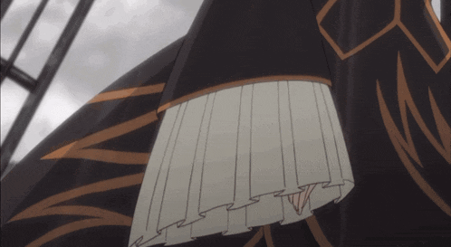 a close up of a person wearing a black and white dress with a pleated skirt