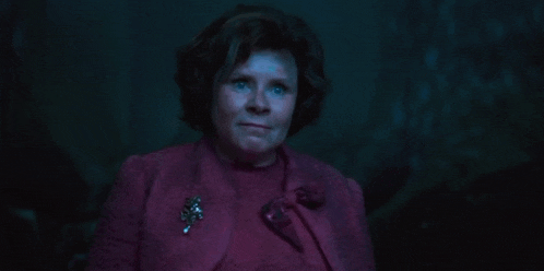 a woman in a purple jacket says no enough in pink letters