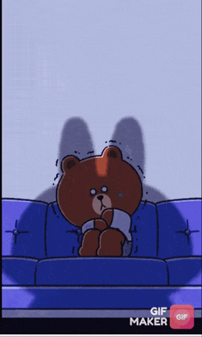a brown teddy bear is sitting on a blue couch with a gif maker button
