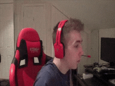 a man wearing red headphones and a red gaming chair