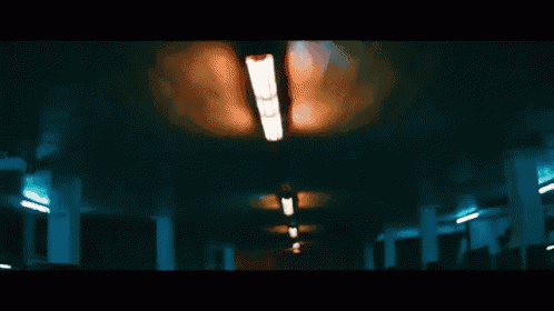 a dark hallway with a light on the ceiling