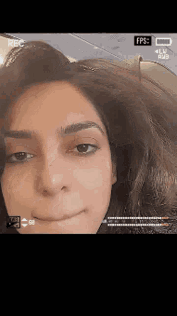 a close up of a woman 's face is being recorded on a phone