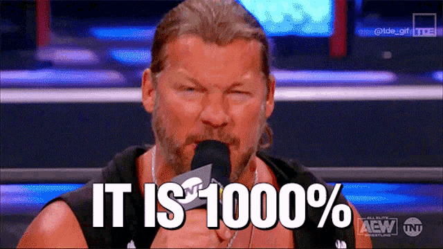 a man speaking into a microphone with the words it is 1000 %