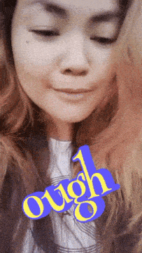 a close up of a woman 's face with the word " ough " written on it