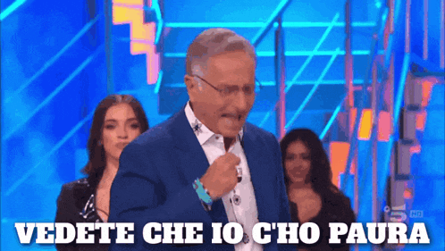 a man in a blue suit says vedete che io cho paura in front of a group of women