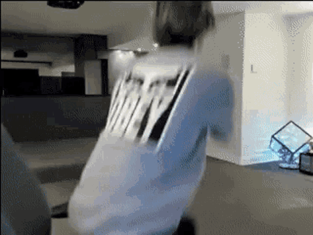 a person wearing a blue shirt with the word nasty on the back