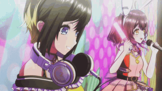 a girl with headphones around her neck singing into a microphone next to another girl