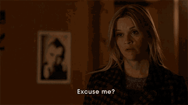 a woman says excuse me while standing in front of a picture