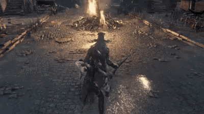 a man is laying on the ground in front of a fire .