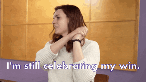 a woman says i 'm still celebrating my win while adjusting her hair