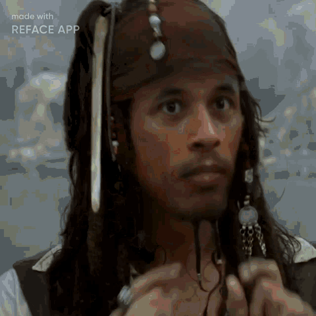 a man with dreadlocks and a bandana on his head looks at the camera .