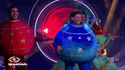 a group of people dressed up as christmas decorations are dancing