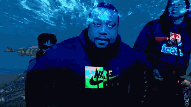 a man wearing a hoodie that says icon laughs