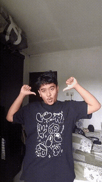 a boy wearing a black shirt with a drawing of a smiley face on it