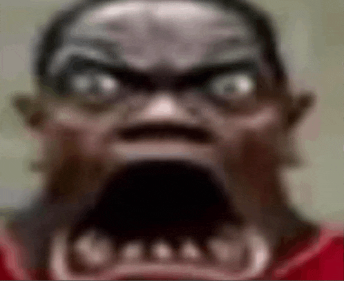a close up of a man 's face with a very large mouth and teeth .