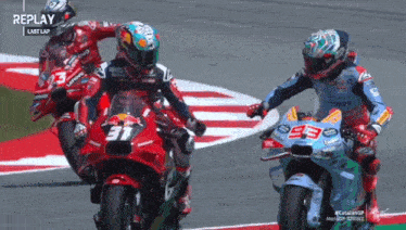 a group of motorcycle racers are racing on a track with replay written on the bottom