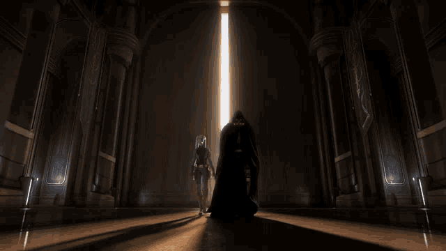 a man and a woman are standing in a dark room with a light coming through the door