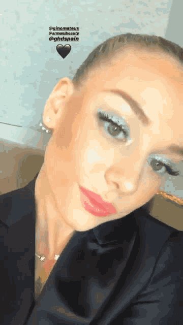 a close up of a woman 's face with a heart in the background