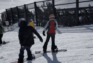 a group of snowboarders are standing in the snow