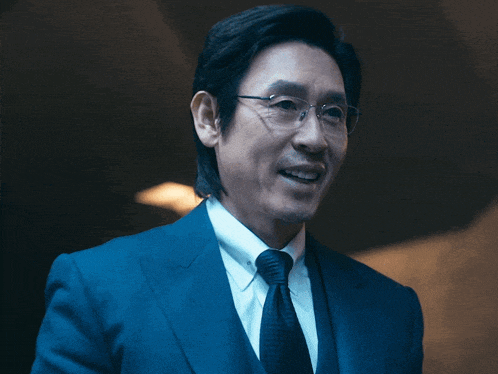 a man in a suit and tie is smiling
