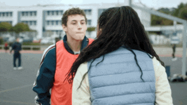 a man and a woman are standing next to each other on a court