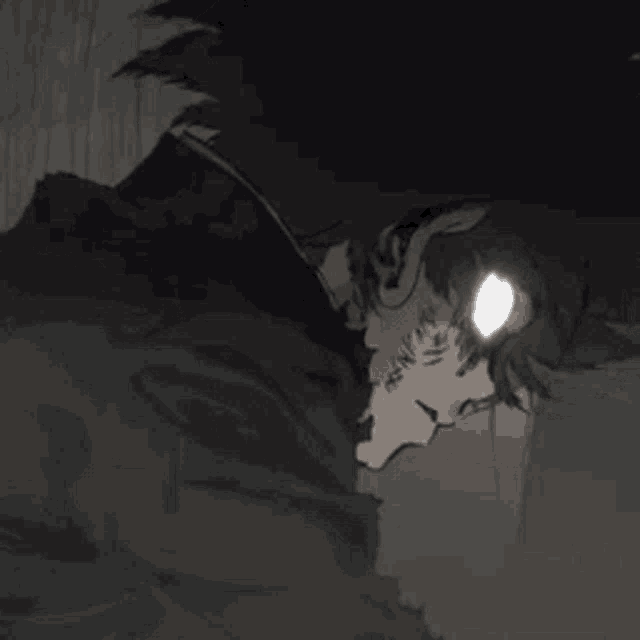 a close up of a person 's face with a glowing eye .
