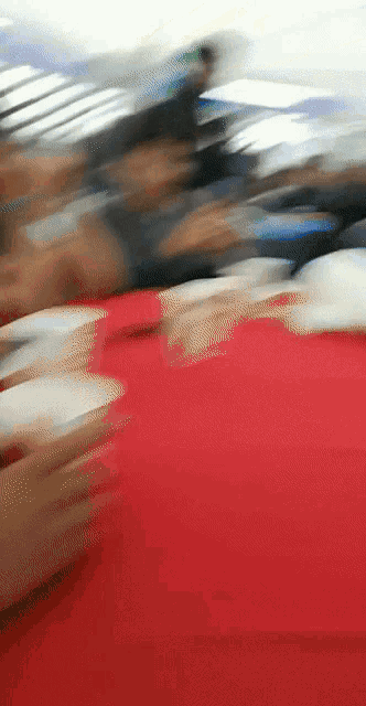a blurry picture of a person 's face with a red shirt