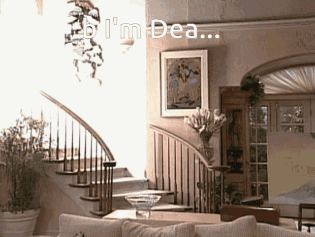 a living room with stairs and a sign that says " i 'm dea " on it