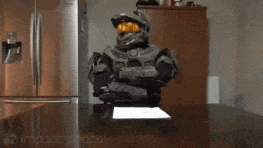 a man in a halo costume is sitting at a table with a piece of paper on it