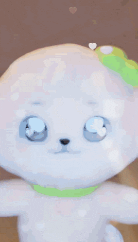 a close up of a stuffed animal with a green bow
