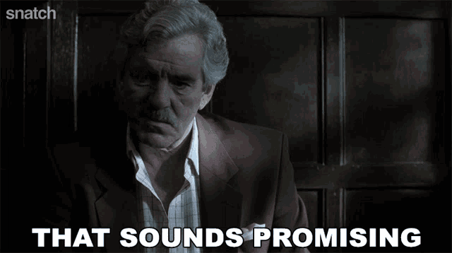 a man in a suit says that sounds promising on a screen