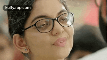 a close up of a woman wearing glasses .