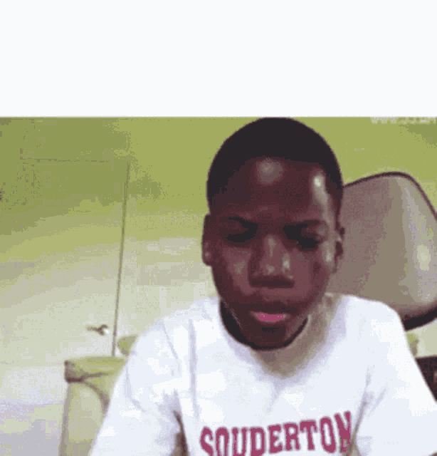a young man wearing a shirt that says souderton on it