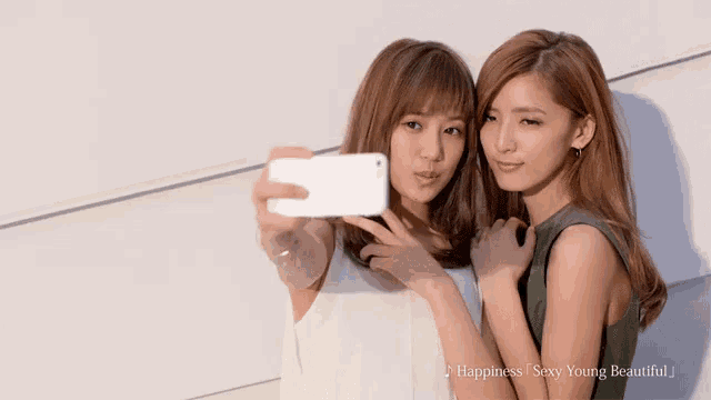 two women are taking a selfie with happiness sexy young beautiful written on the bottom