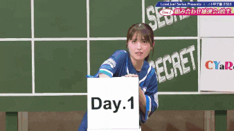 a girl holding a sign that says day 1 on it