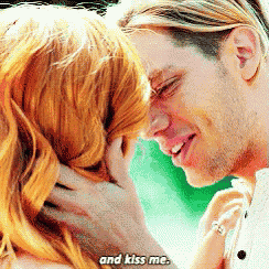 a man and a woman are looking into each other 's eyes and the man is saying and kiss me