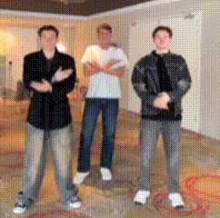 three men are posing for a picture in a living room
