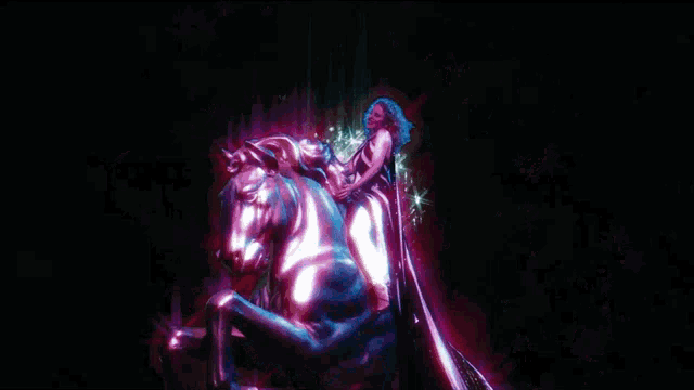 a statue of a woman riding a horse is surrounded by stars