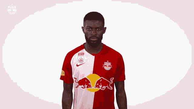 a man in a red and white red bull jersey