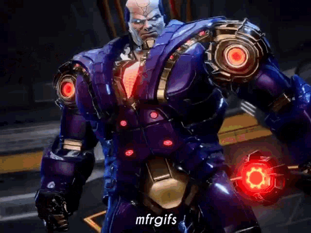 a man in a blue robot suit is standing in a dark room and talking .