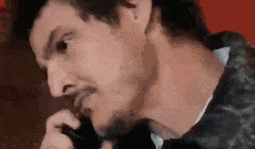 a close up of a man talking on a phone