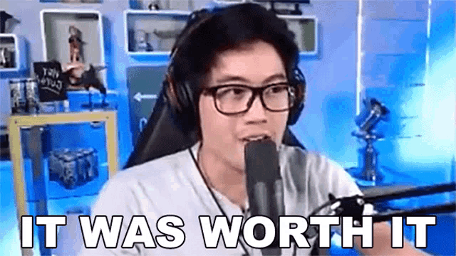 a man wearing headphones and glasses is sitting in front of a microphone and says `` it was worth it '' .